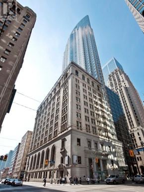 Toronto (Bay Street Corridor) condo for rent - A street view of a city with a mix of old and new buildings.