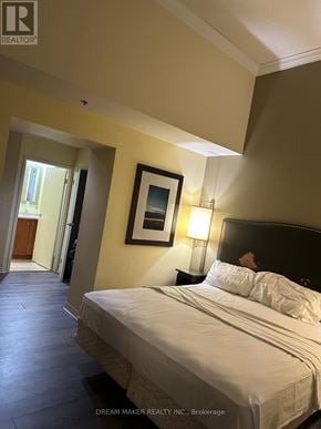 Toronto (Bay Street Corridor) condo for rent - A bedroom with a bed, lamp, and picture frame.
