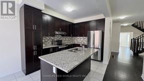 East Gwillimbury apartment for rent - A kitchen with granite countertops and a stainless steel refrigerator.
