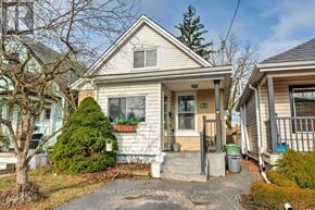 Hamilton (Eastmount) apartment for rent - A house with a sign that says "RE/MAX ESCAPEMENT INC. Brokerage".
