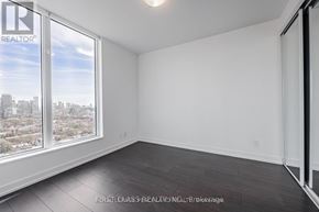 Toronto (Kensington-Chinatown) condo for rent - A room with a large window overlooking a cityscape.