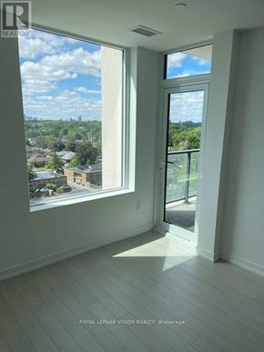 Toronto (Humber Heights) condo for rent - A room with a large window overlooking a residential area.
