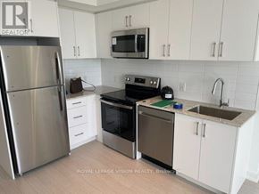 Toronto (Humber Heights) condo for rent - A kitchen with a stainless steel refrigerator, black oven, and white cabinets.
