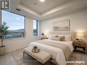 Oakville (Ga Glen Abbey) condo for rent - A bedroom with a large bed, a nightstand, and a window overlooking a cityscape.