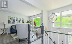 Kitchener apartment for rent - A well-lit room with a white sofa and a chandelier hanging from the ceiling.