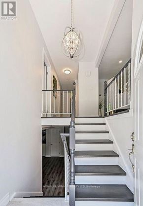 Kitchener apartment for rent - A staircase with a chandelier hanging above it.