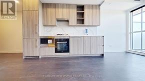 Toronto (Bayview Village) condo for rent - A modern kitchen with wooden cabinets and appliances.