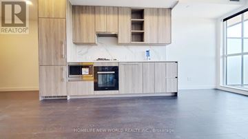 Toronto (Bayview Village) condo for rent - A modern kitchen with wooden cabinets and appliances.