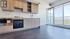 Toronto (Bayview Village) condo for rent - A modern kitchen with wooden cabinets and a marble backsplash.