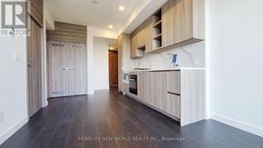 Toronto (Bayview Village) condo for rent - A modern kitchen with wooden cabinets and a marble backsplash.