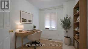 Toronto (West Hill) townhouse for rent - A room with a desk, chair, and a plant.