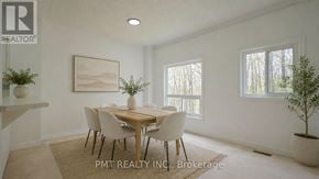 Toronto (West Hill) townhouse for rent - A dining room with a table set for four and a plant on the side table.