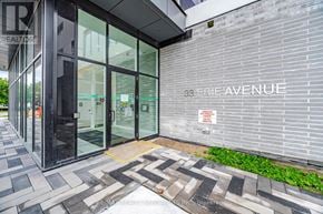 Brantford condo for rent - The image shows the entrance to a building with glass doors and a sign that reads "33 Erie Avenue."