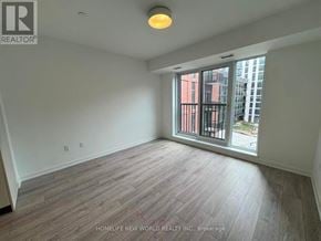 Toronto (Regent Park) condo for rent - A room with a window overlooking a cityscape is for sale.