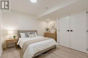 Ottawa apartment for rent - A bedroom with a bed, nightstand, and wardrobe.
