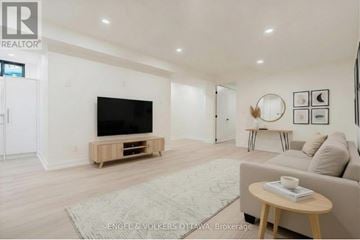 Ottawa apartment for rent - A living room with a flat screen TV and a couch.