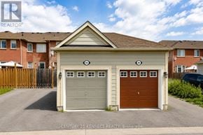 Markham (Cornell) apartment for rent - A garage with a brown door is in front of a house.