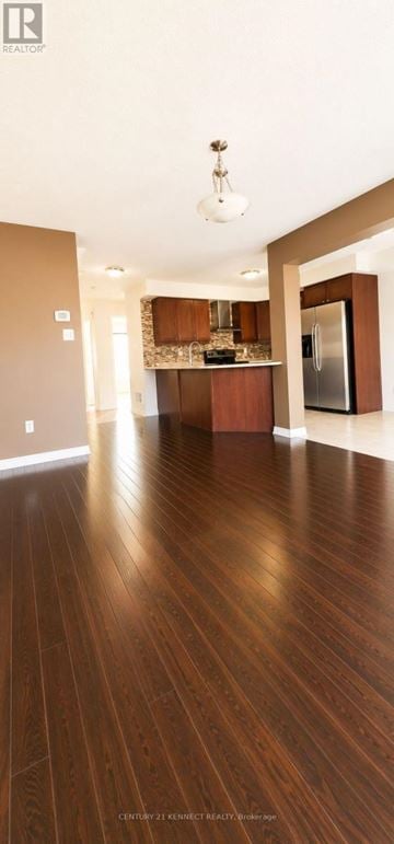 Markham (Cornell) apartment for rent - A spacious kitchen with wooden floors and a refrigerator.