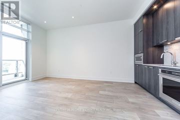 Toronto (Dovercourt-Wallace Emerson-Junction) condo for rent - A spacious kitchen with wooden cabinets and a large window.