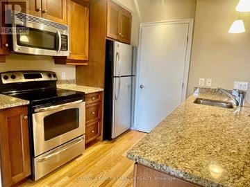Ottawa condo for rent - A kitchen with granite countertops and stainless steel appliances.