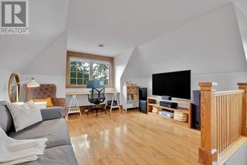 Ottawa apartment for rent - A living room with a grey couch and a wooden floor.
