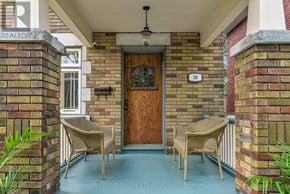 Ottawa apartment for rent - A front porch with a wooden door and two wicker chairs.
