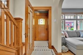 Ottawa apartment for rent - A hallway with a wooden door and a tiled floor.