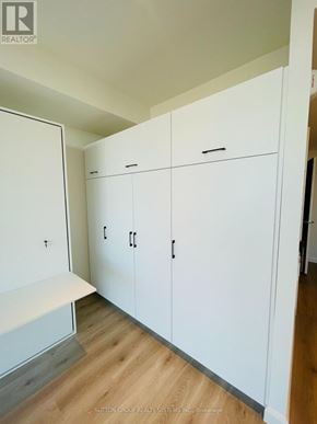 Kitchener condo for rent - A white cabinet with a black handle is in the room.