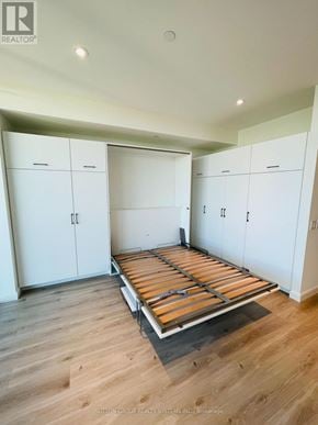 Kitchener condo for rent - A bedroom with a bed frame in the middle of the room.