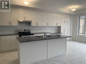 East Gwillimbury (Holland Landing) apartment for rent - A kitchen with white cabinets and a black countertop.