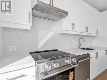 Vaughan (Vellore Village) condo for rent - A modern kitchen with a stainless steel oven and white cabinets.