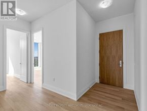 Vaughan (Vellore Village) condo for rent - A room with a wooden door and white walls.