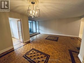 Toronto (Eringate-Centennial-West Deane) condo for rent - A room with a wooden floor and a chandelier.