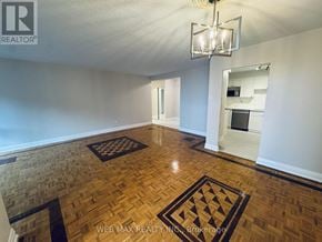 Toronto (Eringate-Centennial-West Deane) condo for rent - A room with wooden flooring and a chandelier.