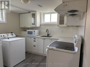 Welland (Lincoln/Crowland) apartment for rent - A white kitchen with a washing machine and a microwave.