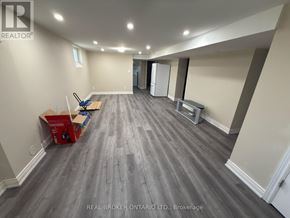 Welland (Lincoln/Crowland) apartment for rent - A room with grey flooring and white walls is shown with a Real Broker Ontario Ltd. logo.