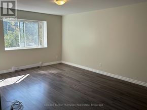 Huntsville (Chaffey) triplex for rent - A room with a window and wooden flooring.