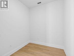 Vaughan (Vellore Village) condo for rent - A white room with wooden flooring and a ceiling fan.