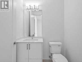 Vaughan (Vellore Village) condo for rent - A white bathroom with a sink, toilet and medicine cabinet.