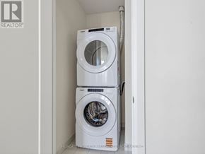 Vaughan (Vellore Village) condo for rent - Two white front load washing machines in a small laundry room.