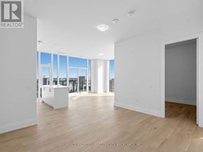 Vaughan (Vellore Village) condo for rent - A spacious, empty room with wooden floors and large windows.