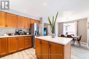 Kitchener apartment for rent - A kitchen with wooden cabinets and a white countertop.