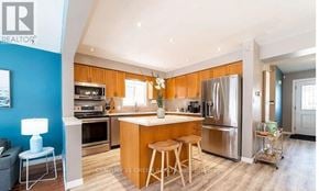 Kitchener apartment for rent - A modern kitchen with wooden cabinets and stainless steel appliances.
