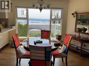 West Vancouver apartment for rent - A dining room with a table and chairs with a view of the water.