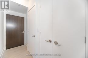 Toronto (Annex) condo for rent - A hallway with a door on the left and two doors on the right.