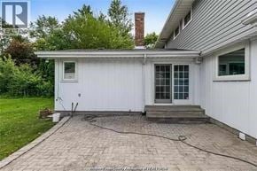 Windsor apartment for rent - A white house with a brick patio in front.
