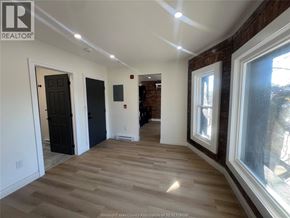 Windsor apartment for rent - A room with wooden floors and white walls, with a window on the right side.