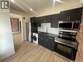 Windsor apartment for rent - A kitchen with black cabinets and stainless steel appliances.
