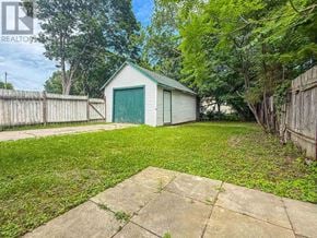 Renfrew apartment for rent - A backyard with a shed and a fence.