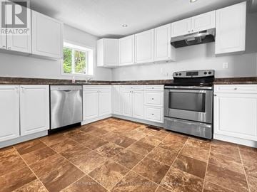 Renfrew apartment for rent - A kitchen with white cabinets and brown tiled flooring.